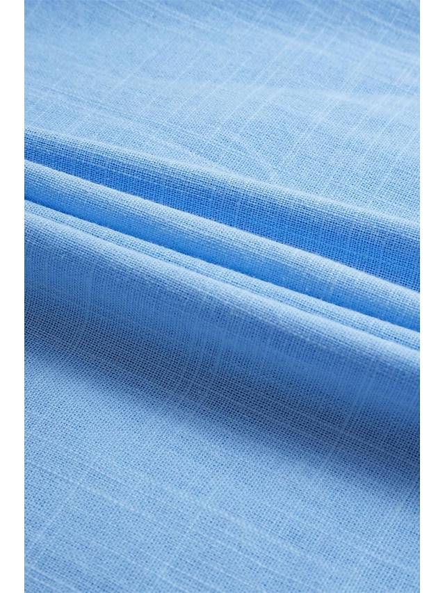 Close-up of light blue textured linen fabric – lightweight and breathable summer shirt material