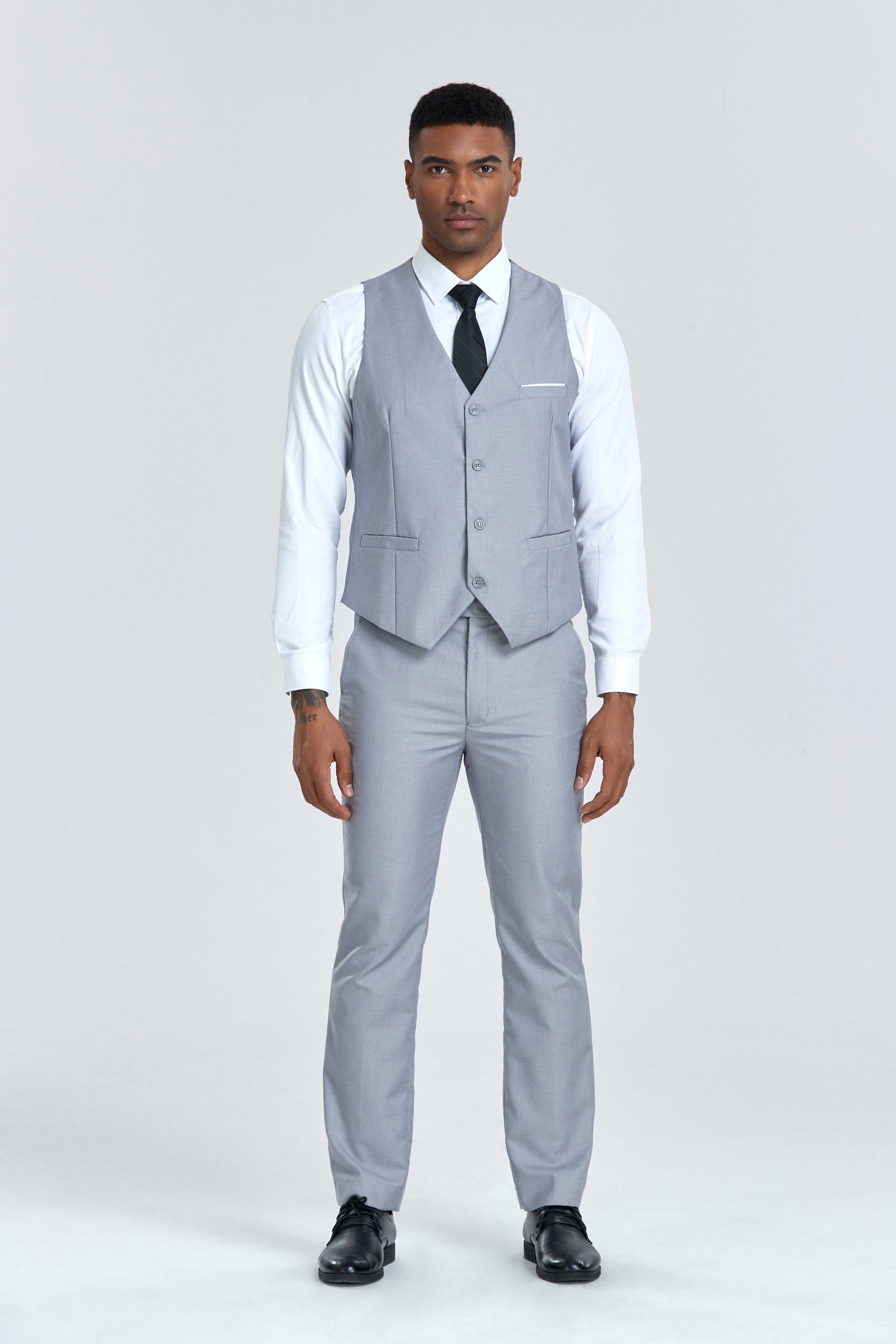 Men’s grey vest and trousers set with black tie, part of elegant 3 piece suit for events