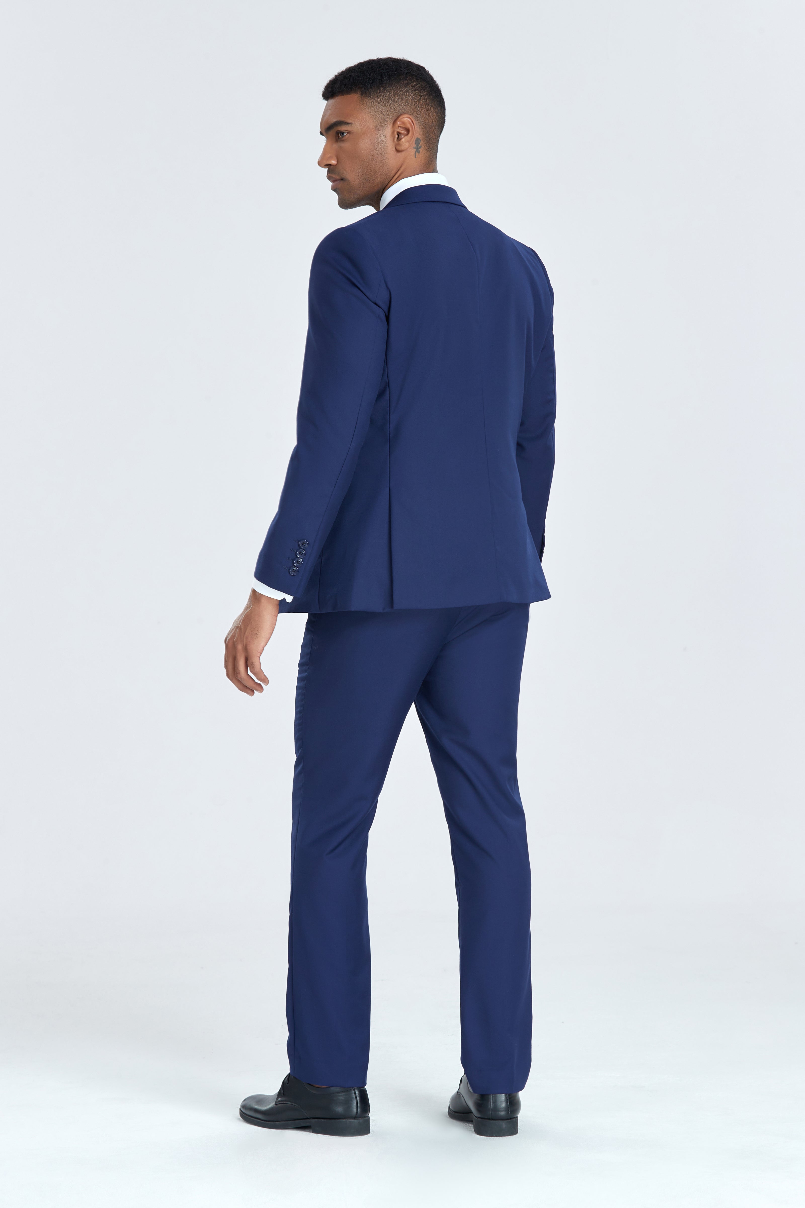 Back view of navy blazer and slim fit trousers in men’s party suit