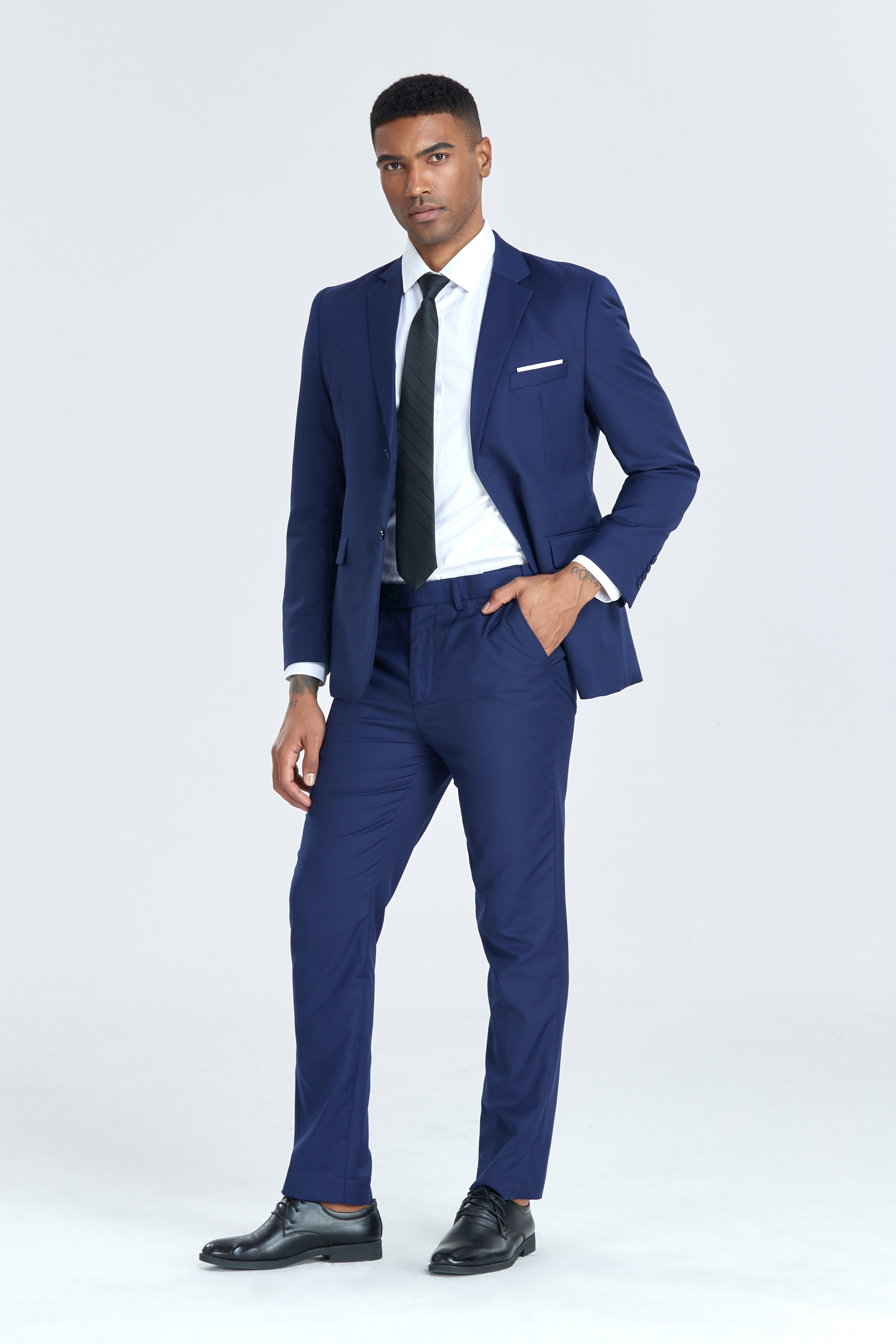 Modern navy suit for men styled with white shirt and black striped tie