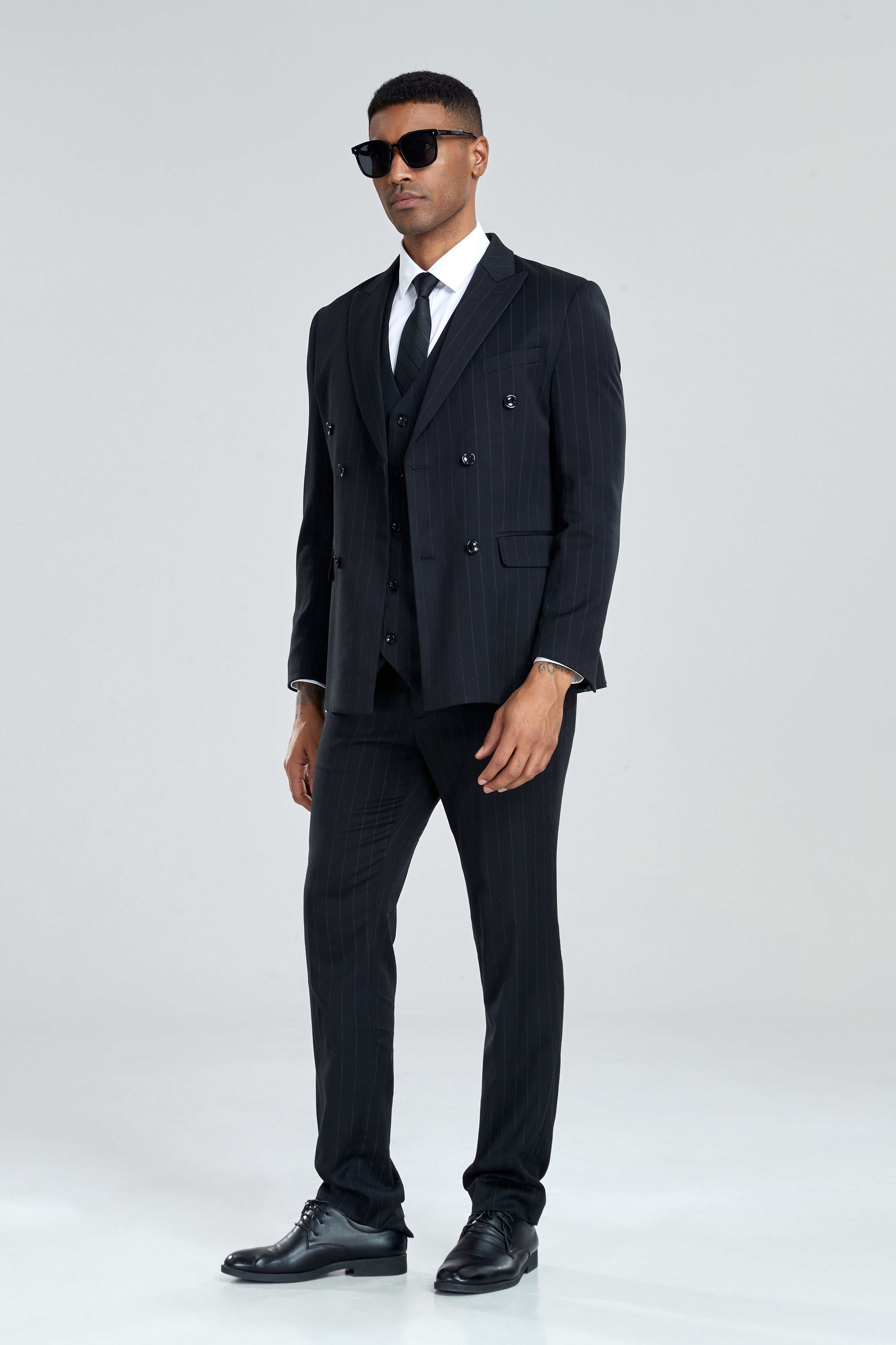 Sharp black striped suit styled for business or evening occasions