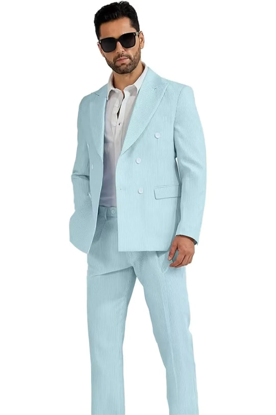 full-body view of a man wearing an aqua blue double-breasted seersucker suit, paired with a white shirt for a sharp summer look.