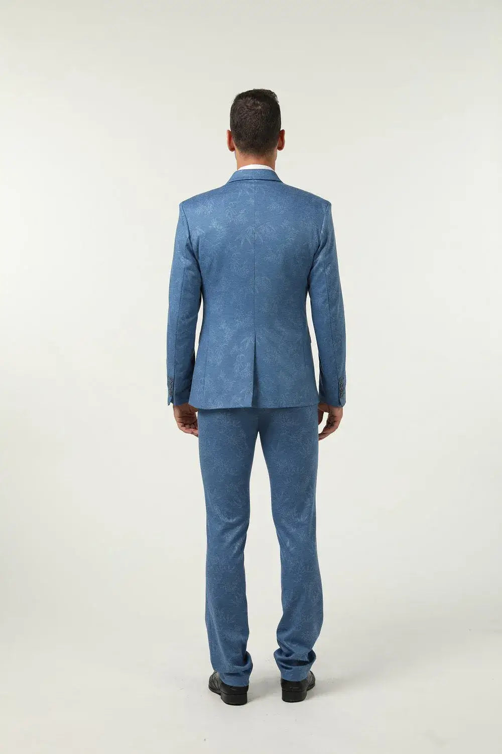 Back view of blue floral patterned men's 3 piece prom suit – bold formal statement attire for events