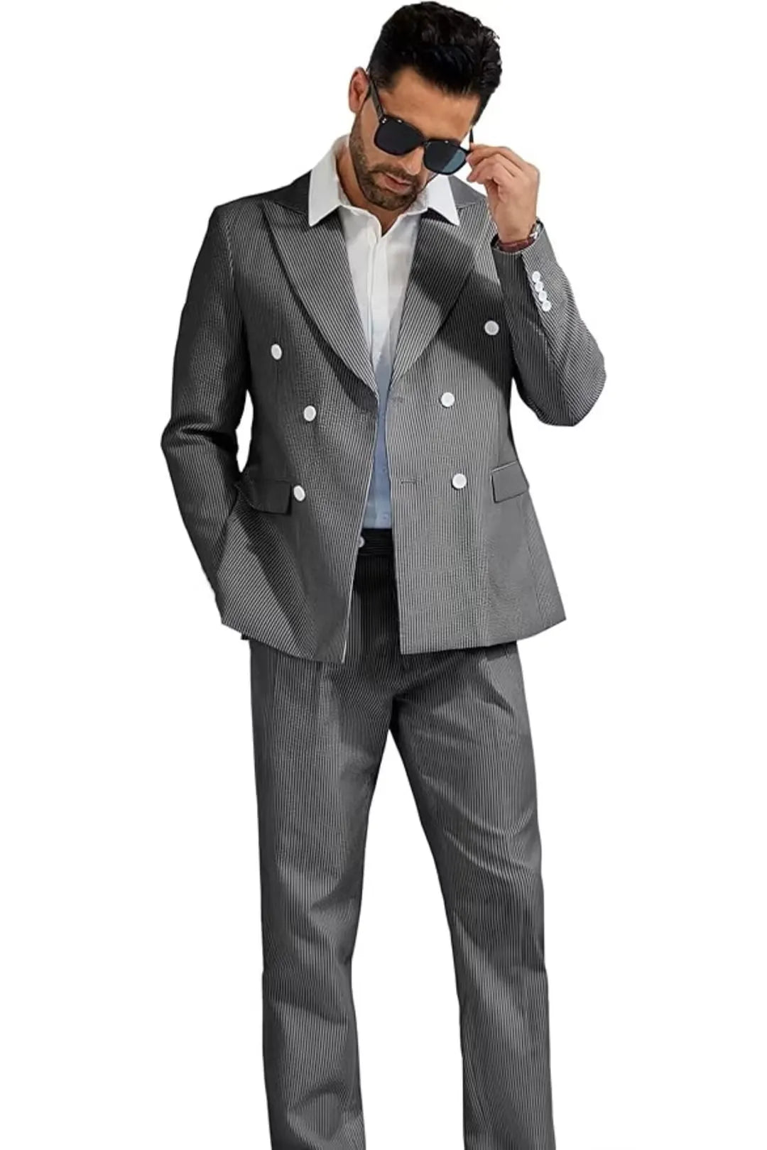 full-body view of a model wearing a black and white striped double-breasted seersucker suit, complete with blazer and trousers.
