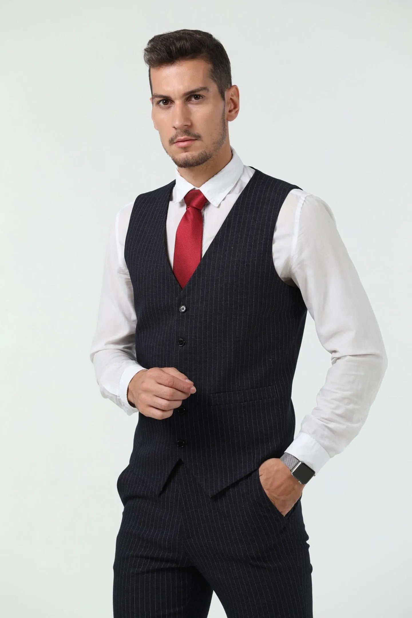 close-up of the black slim fit pinstripe 3 piece suit vest with a red tie and white shirt, showcasing the formal fit.