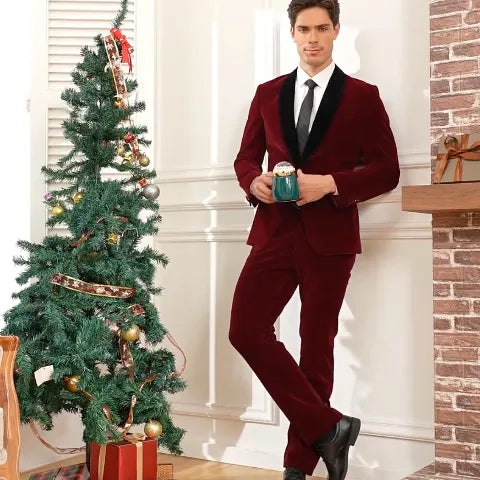 The handsome man is wearing a burgundy velvet prom suit with a black suede lapel. 