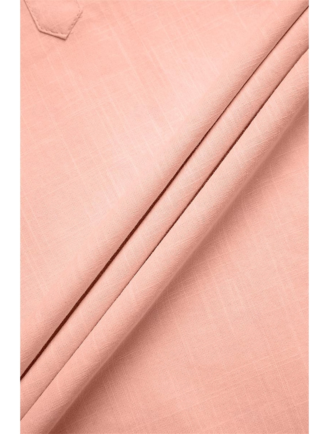 Detailed fabric texture of pink linen shirt – summer-ready plain weave for beach looks