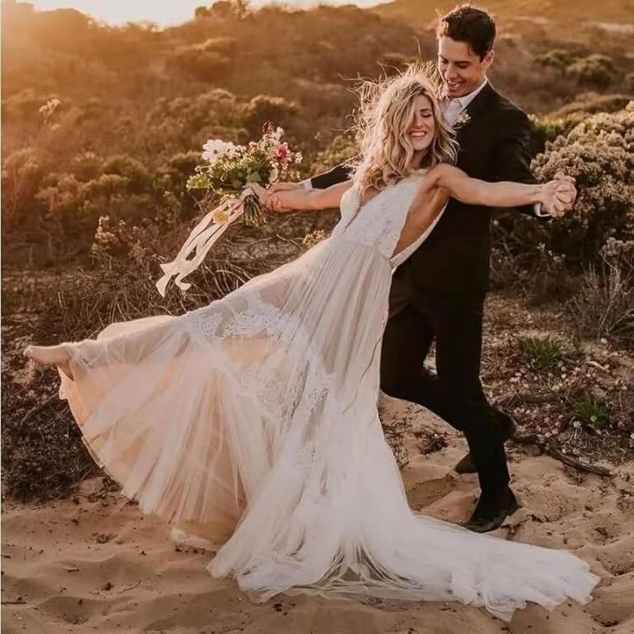 casual black 3 piece suit for men with bow tie in a beach wedding setting