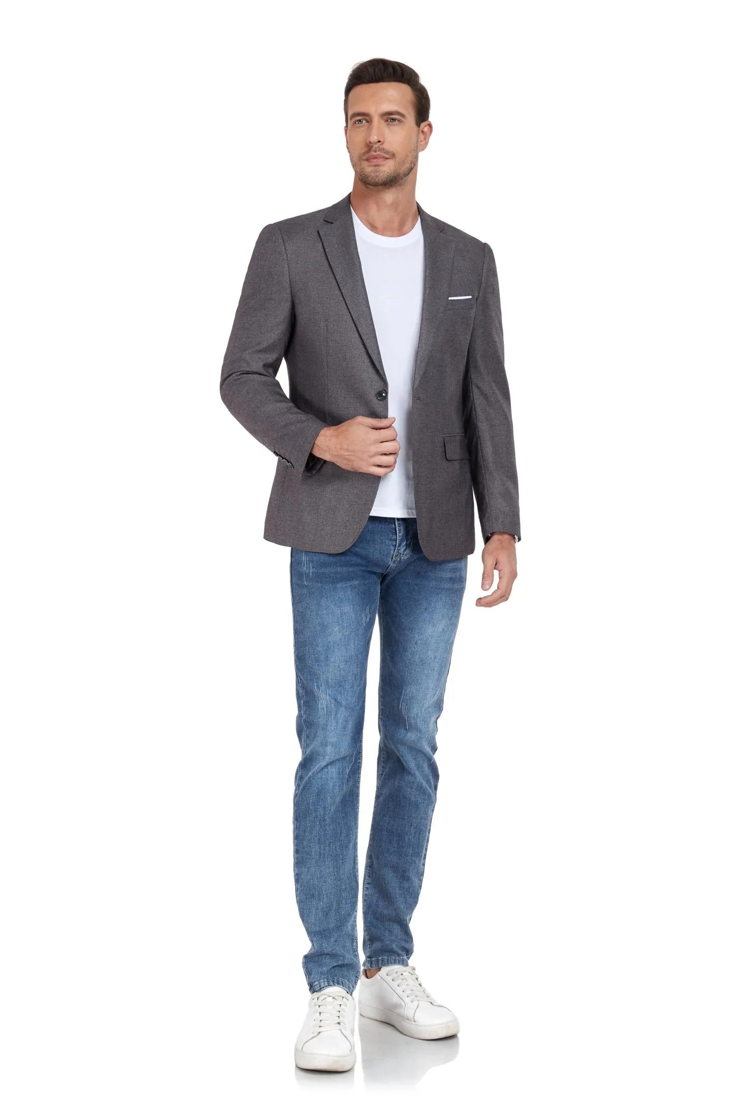 grey two-button blazer, jeans, and sneakers – walking confidently, ideal for business or casual occasions.