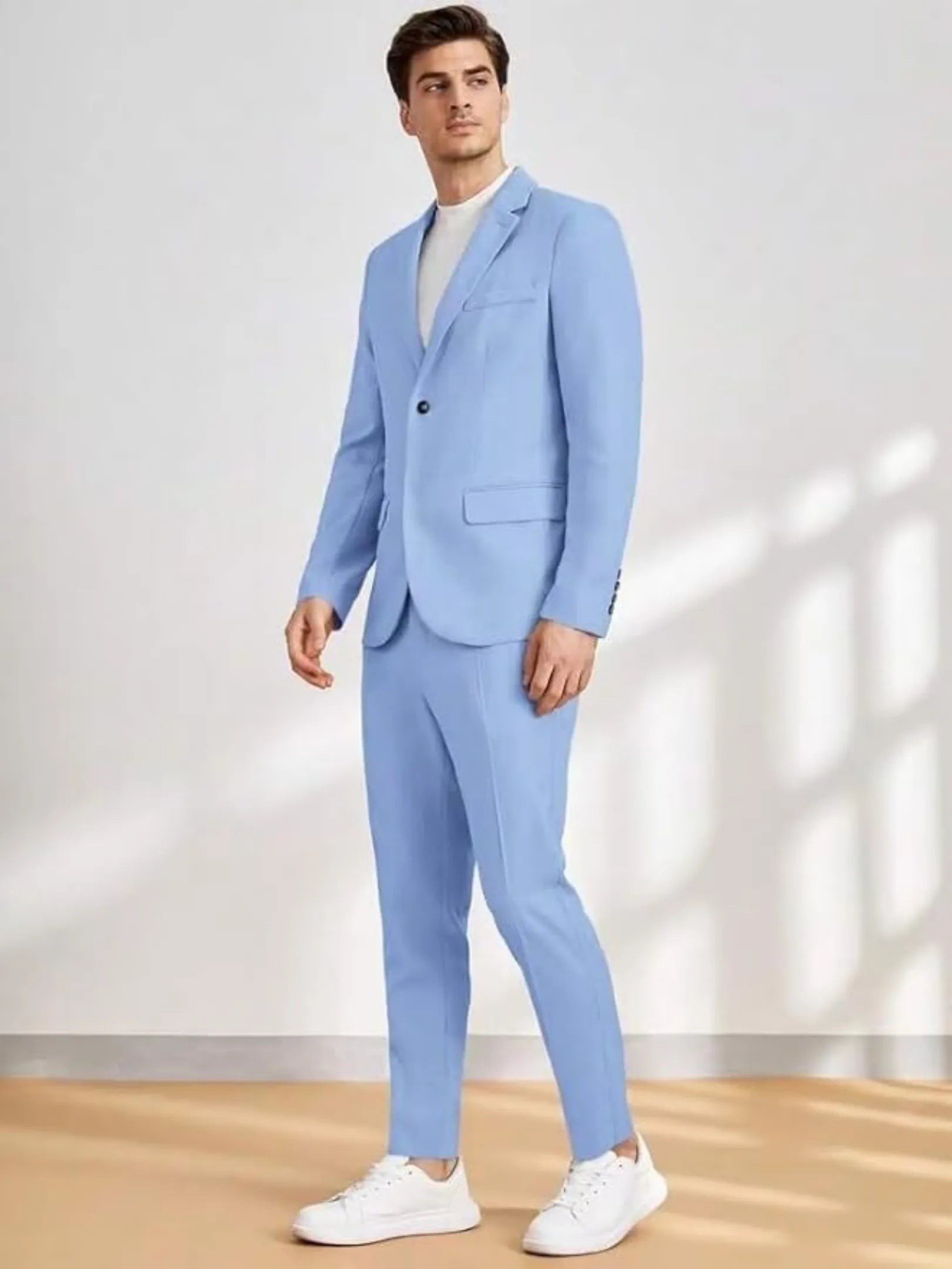 full-body view of man in light blue casual wedding suit with white tee and sneakers
