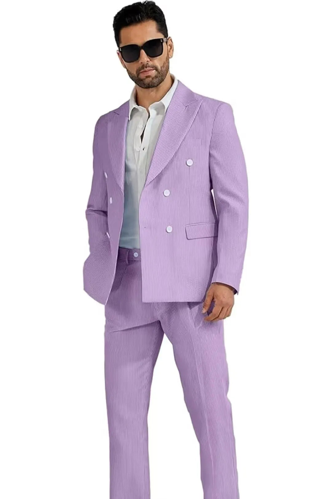 full-body view of a man wearing a light purple double-breasted seersucker suit, paired with a white shirt and casual look.