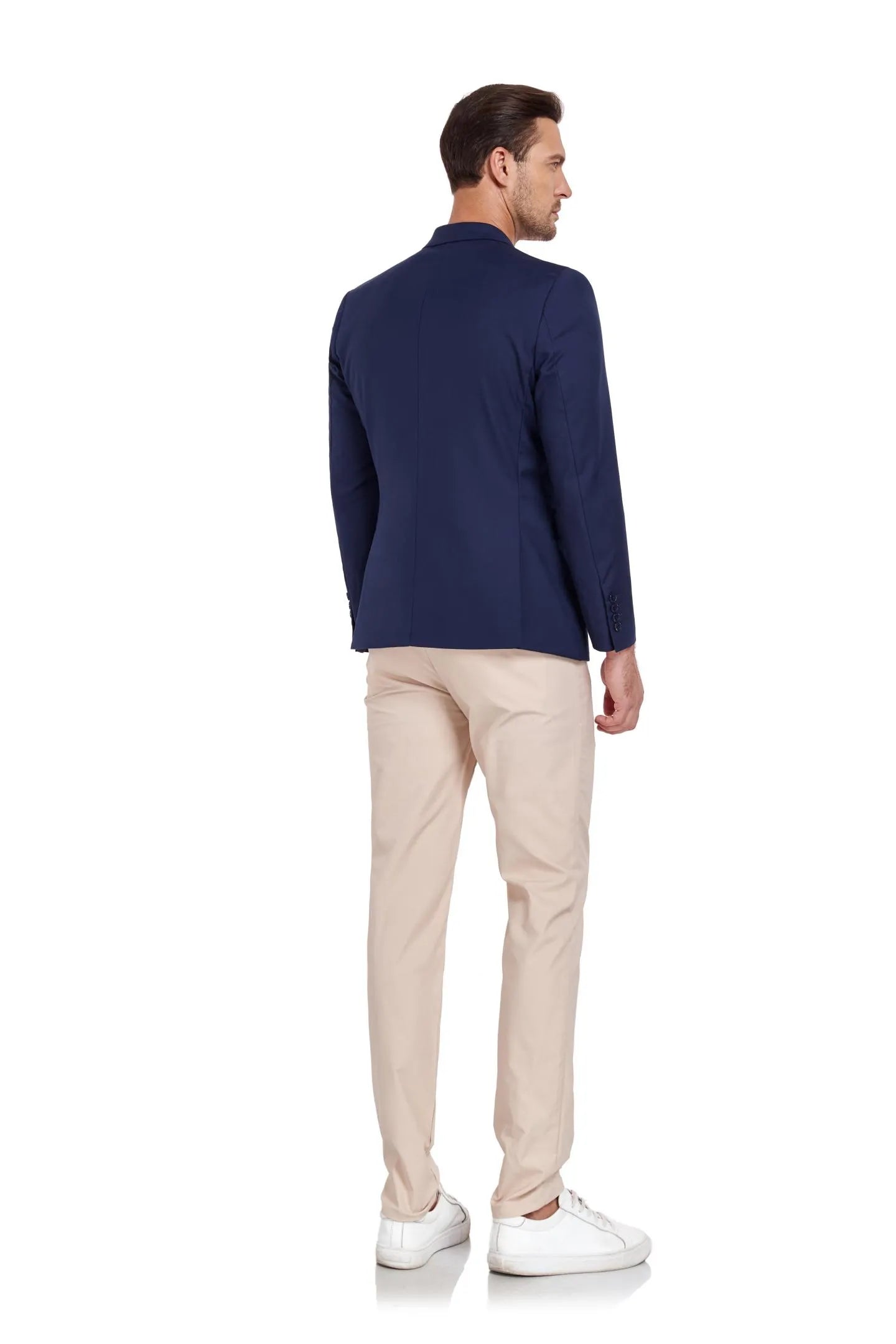 back view of model wearing navy two-button blazer and beige pants – perfect for semi-formal occasions.