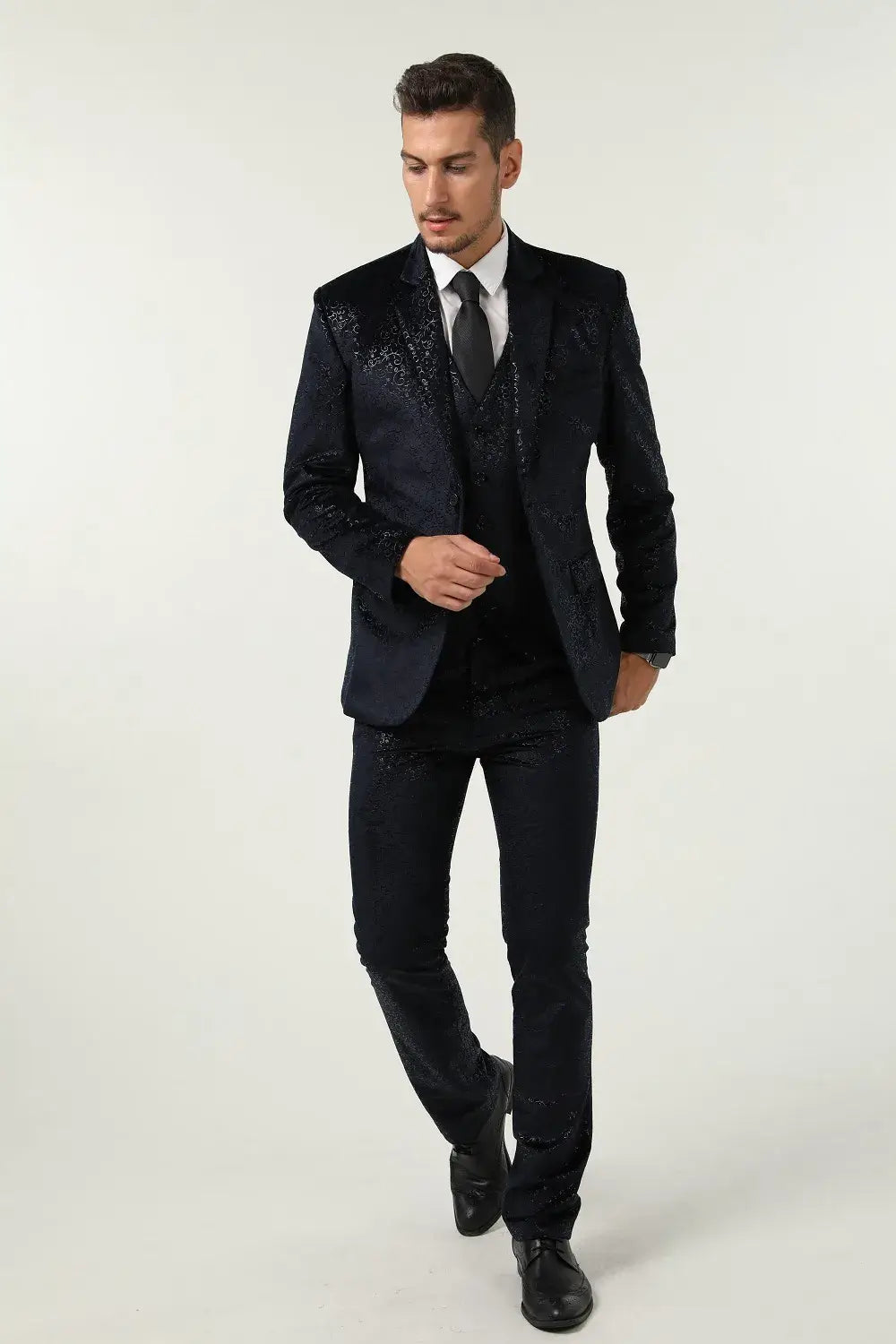 Full front walking view of men's navy velvet 3 piece suit – slim fit prom tuxedo style with confident pose