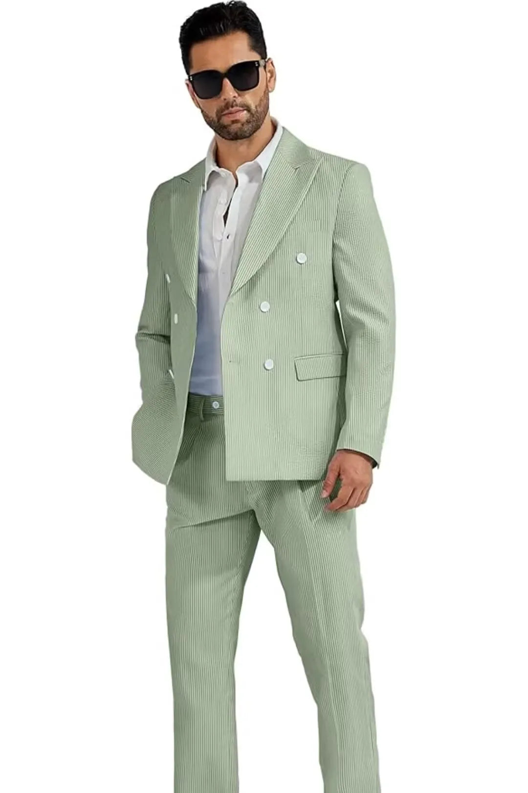 full-body view of a man wearing a sage green double-breasted seersucker suit, paired with sunglasses for a stylish look.