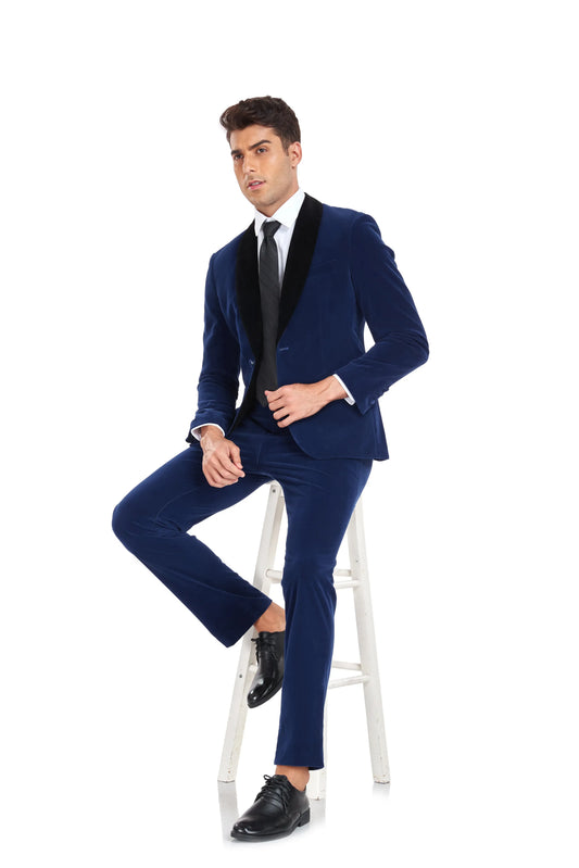 Seated man in royal blue velvet 2 piece suit with black shawl collar – elegant party and event outfit
