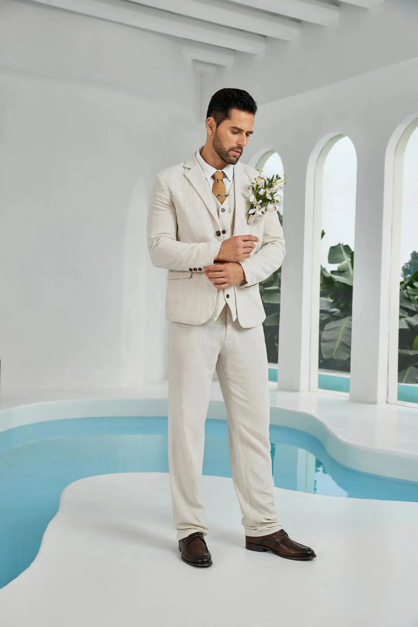 beige linen 3 piece wedding suit for men – elegant blazer, vest, and trousers styled with floral boutonniere