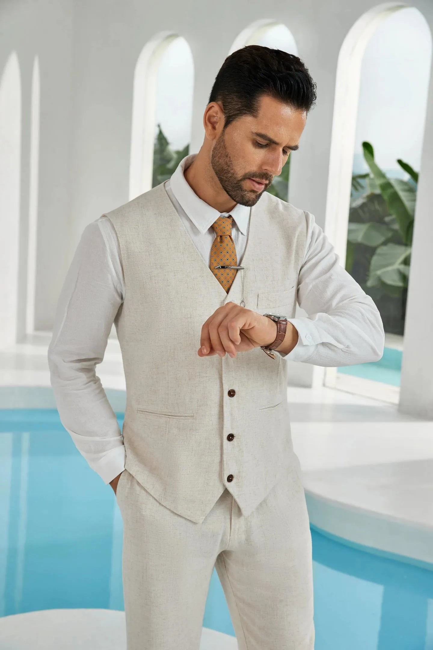 close-up of beige linen 2 piece suit for men – stylish vest and pants paired with white shirt and patterned tie