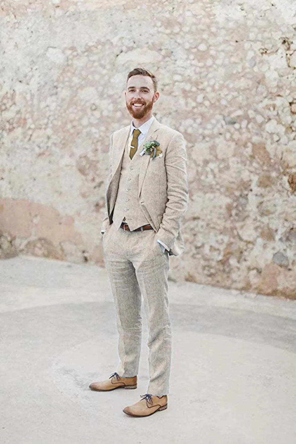 Beige 3 piece linen suit for men with blazer, vest, and pants – summer wedding outfit styled with tie and boutonniere for retro beach groom look.