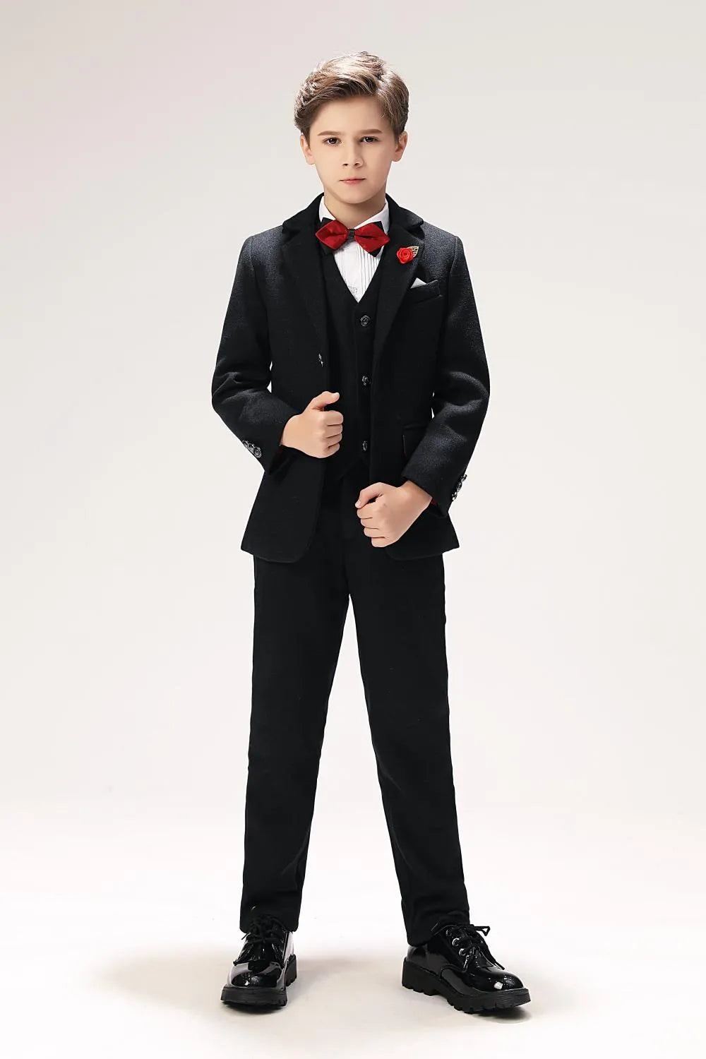 Boys' formal wool suit with red bow tie and lapel flower, styled for weddings or elegant parties