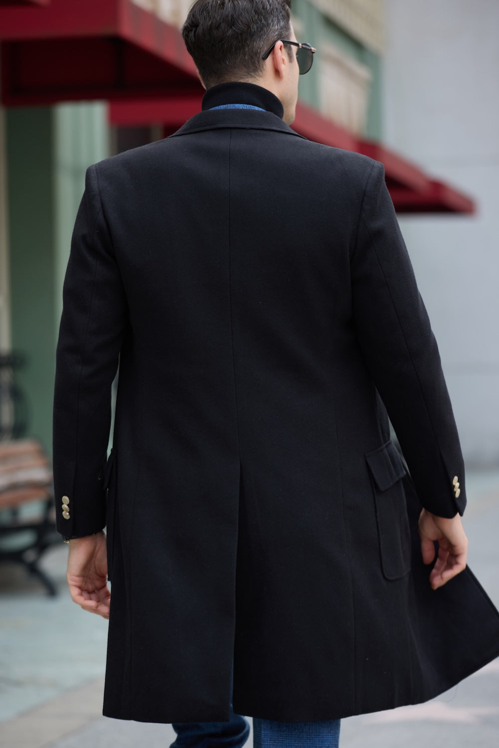 Back view of black men’s wool overcoat – tailored winter coat with rear vent detail