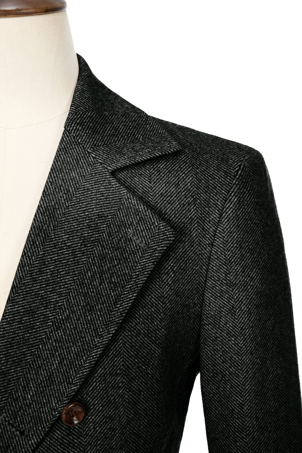 Black close-up of lapel detail on double-breasted wool coat
