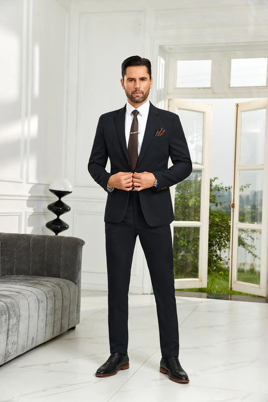 Model wearing black striped 2 piece men's suit with tailored blazer and trousers, styled with white shirt and brown tie in business formal look