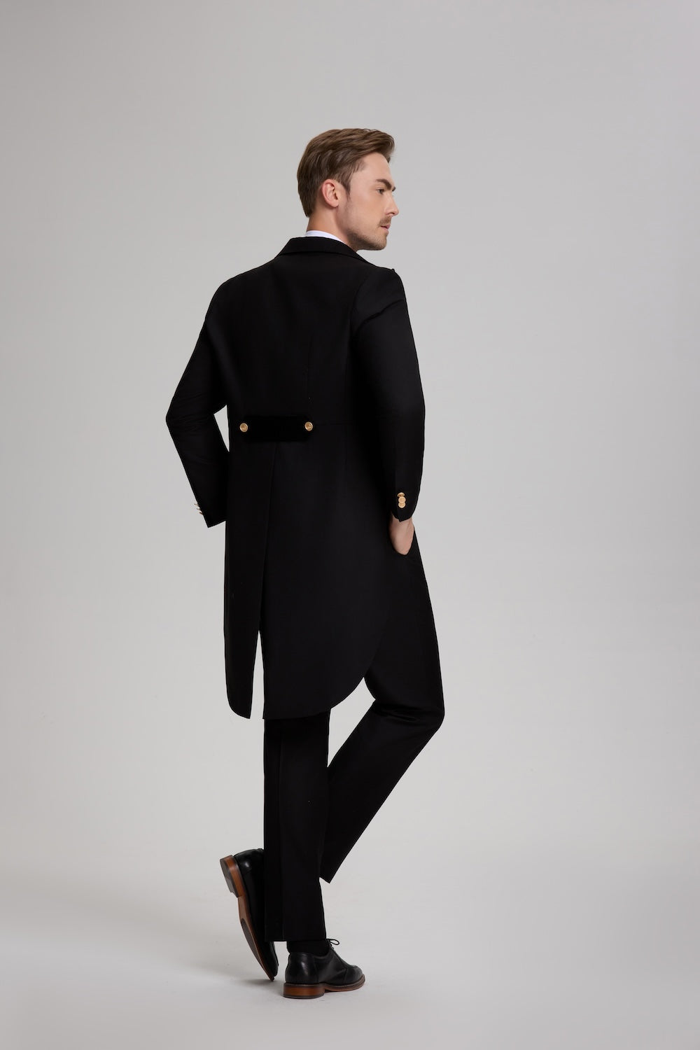 Back view of long tailcoat in black tuxedo – formal evening outfit for men