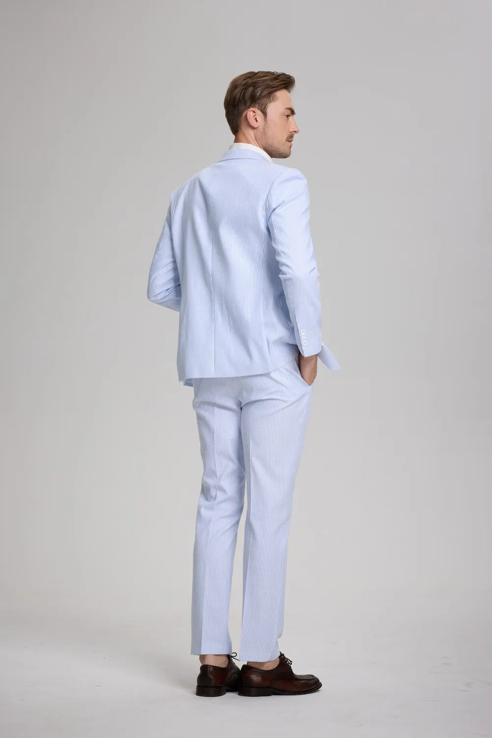 Rear view of blue striped seersucker suit with relaxed pose and hands in pockets