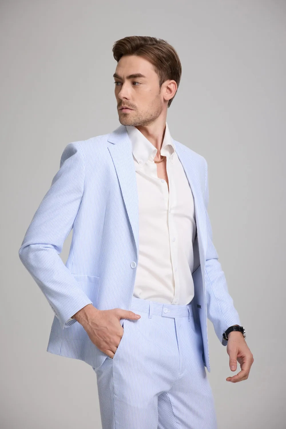Side angle showing blazer pockets and lapel details on blue seersucker suit
