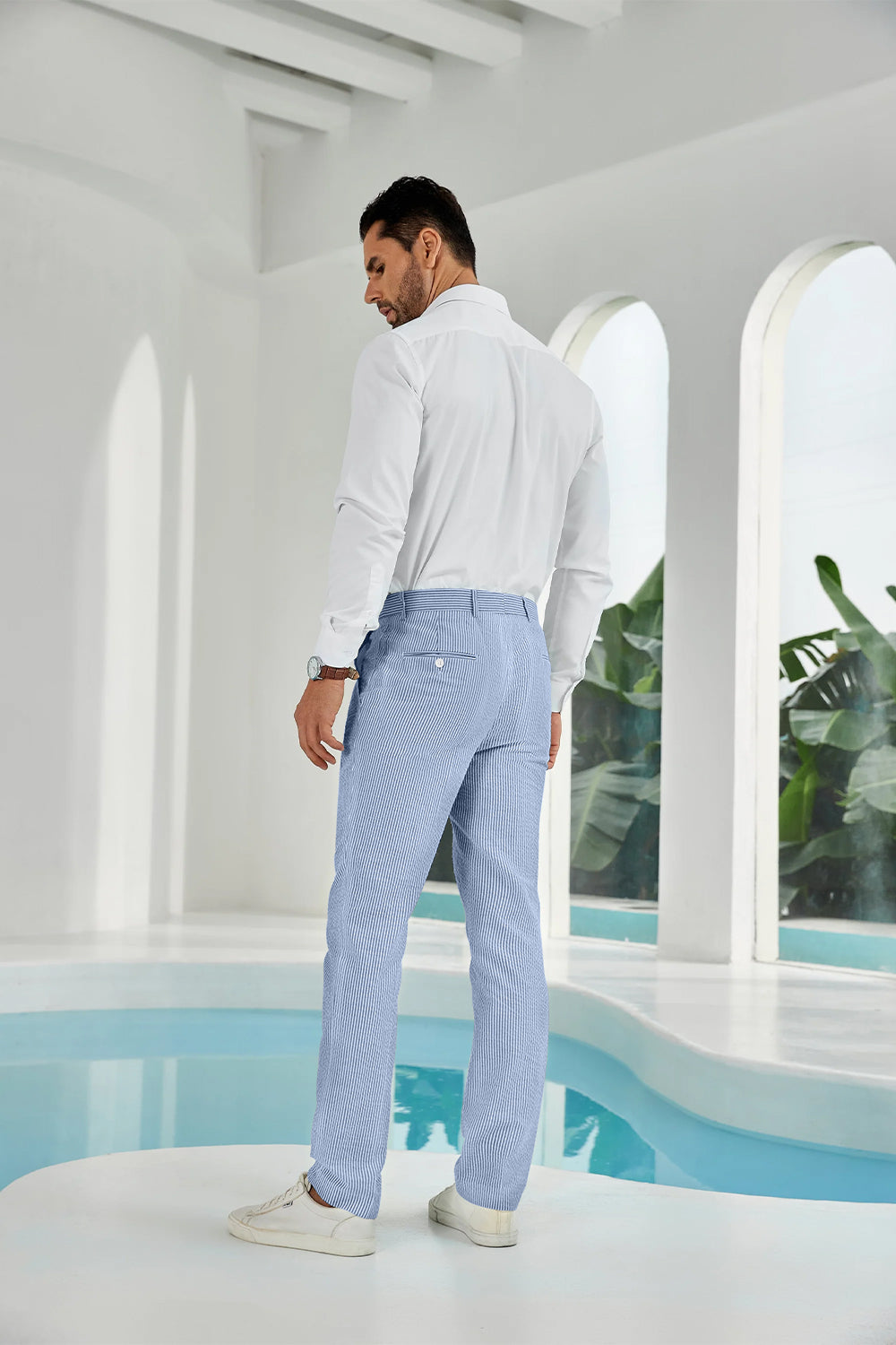 Three-quarter rear angle of blue pants showing slim fit and texture