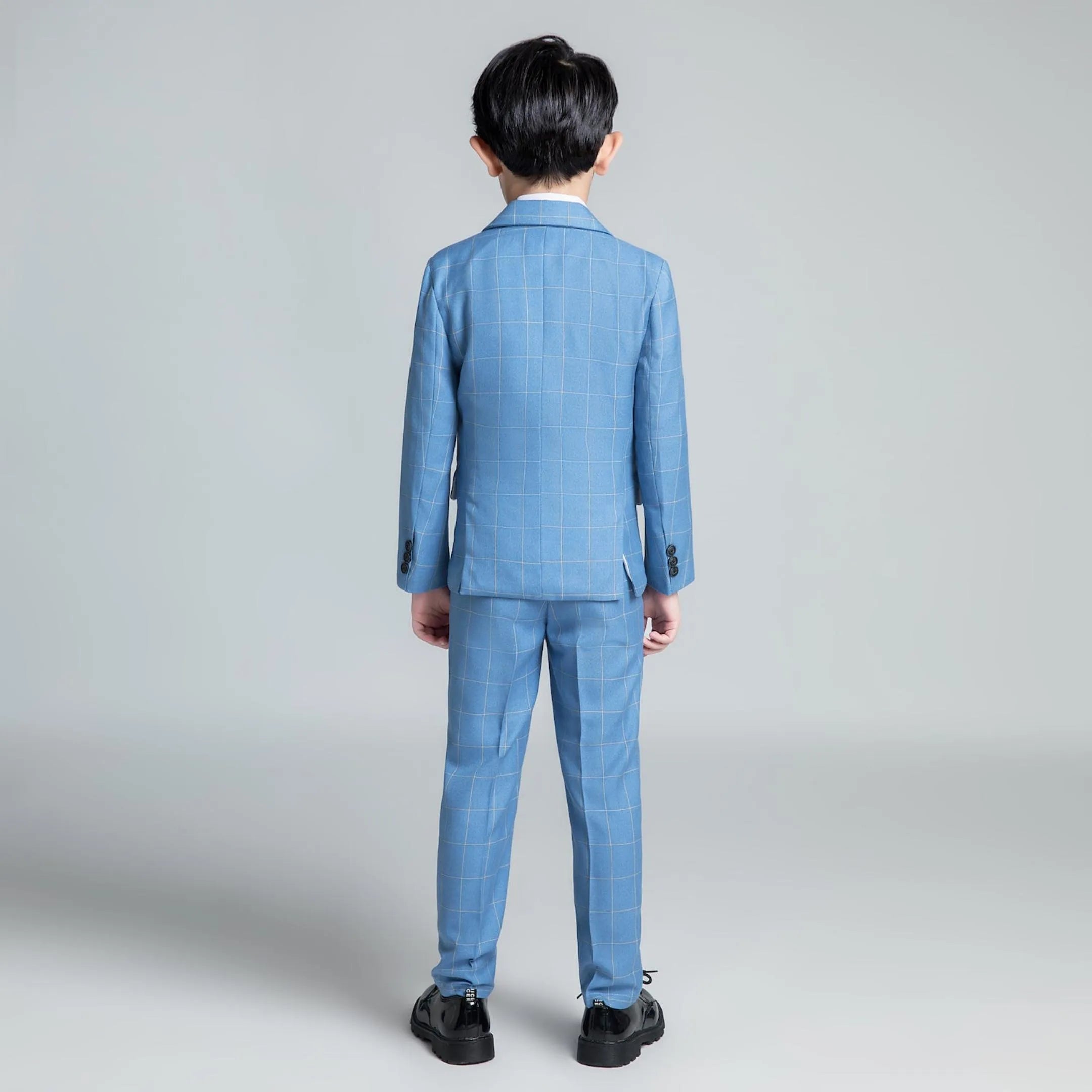Back view of tailored light blue plaid boys suit for formal occasions