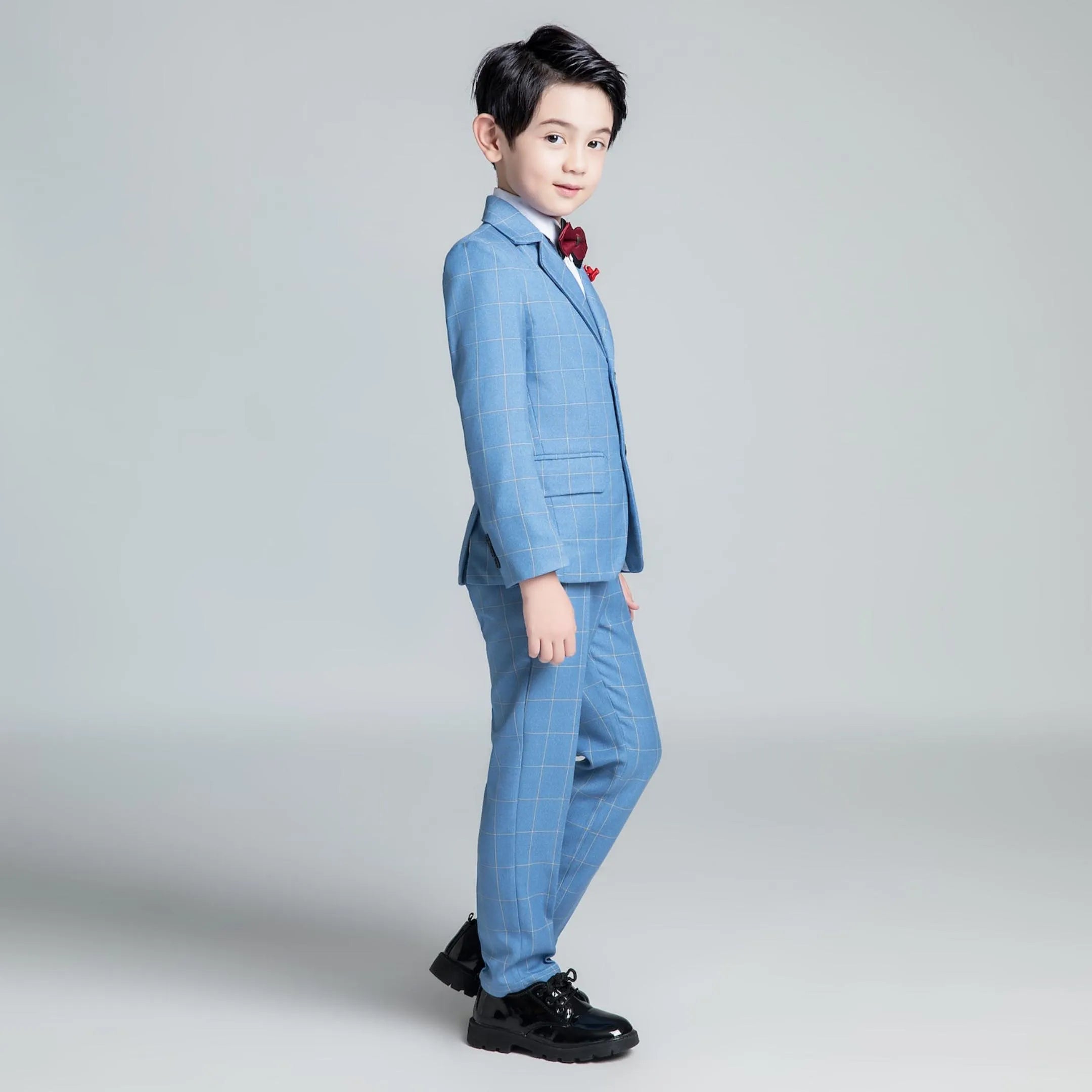 Side profile of blue plaid boys suit set featuring single-breasted jacket