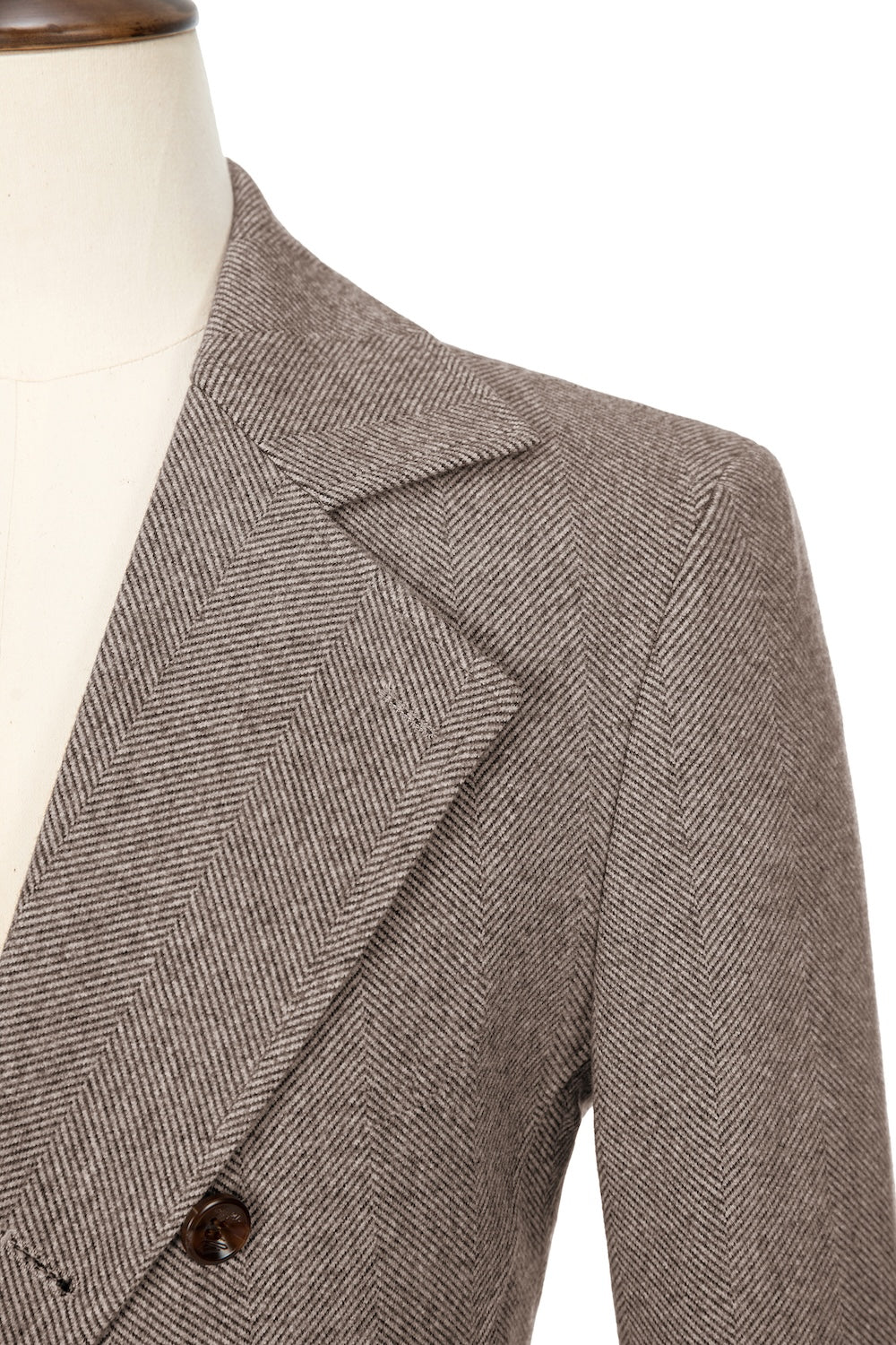 Coffee close-up of lapel detail on double-breasted wool coat