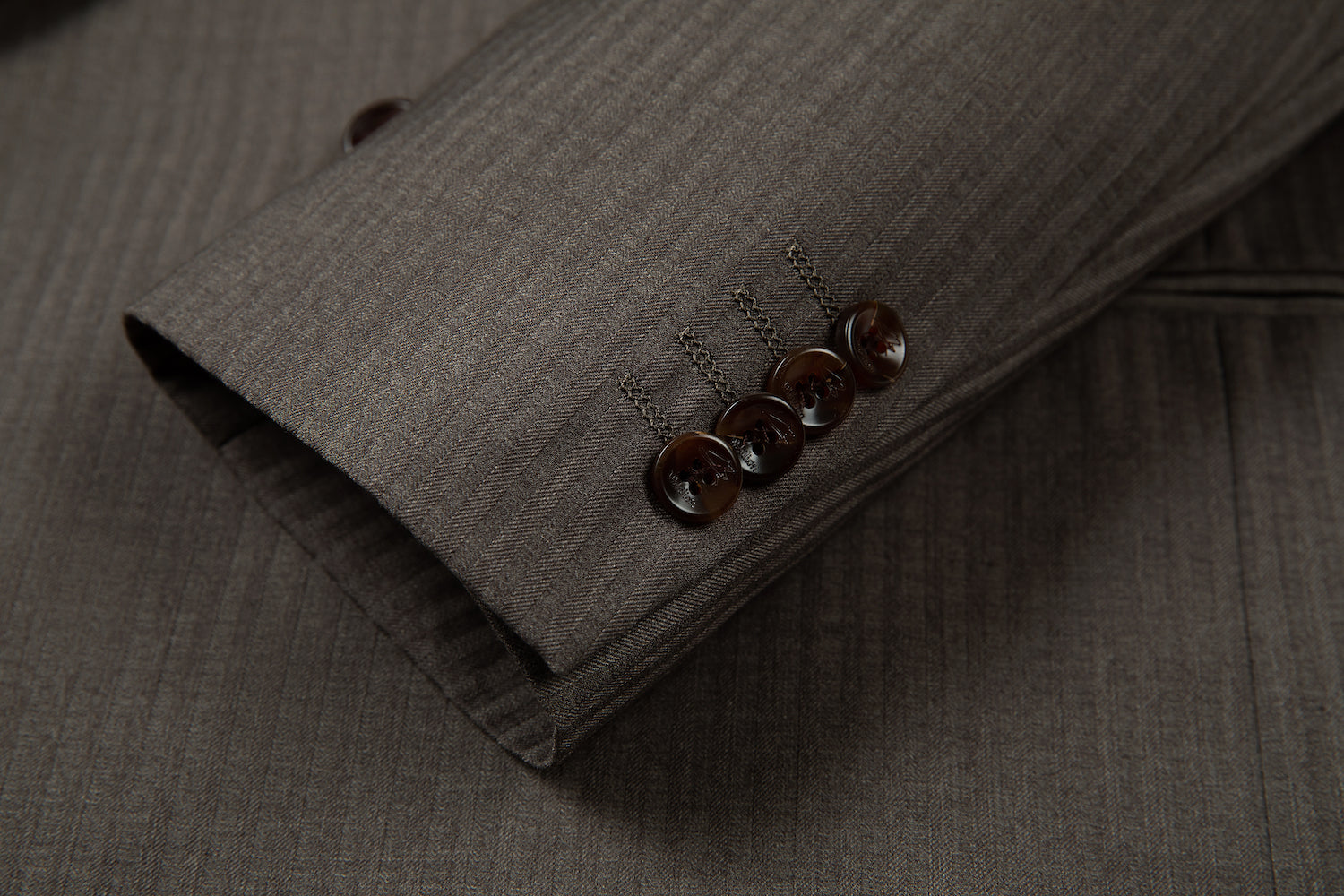 Close-up of sleeve buttons on pinstripe designer blazer