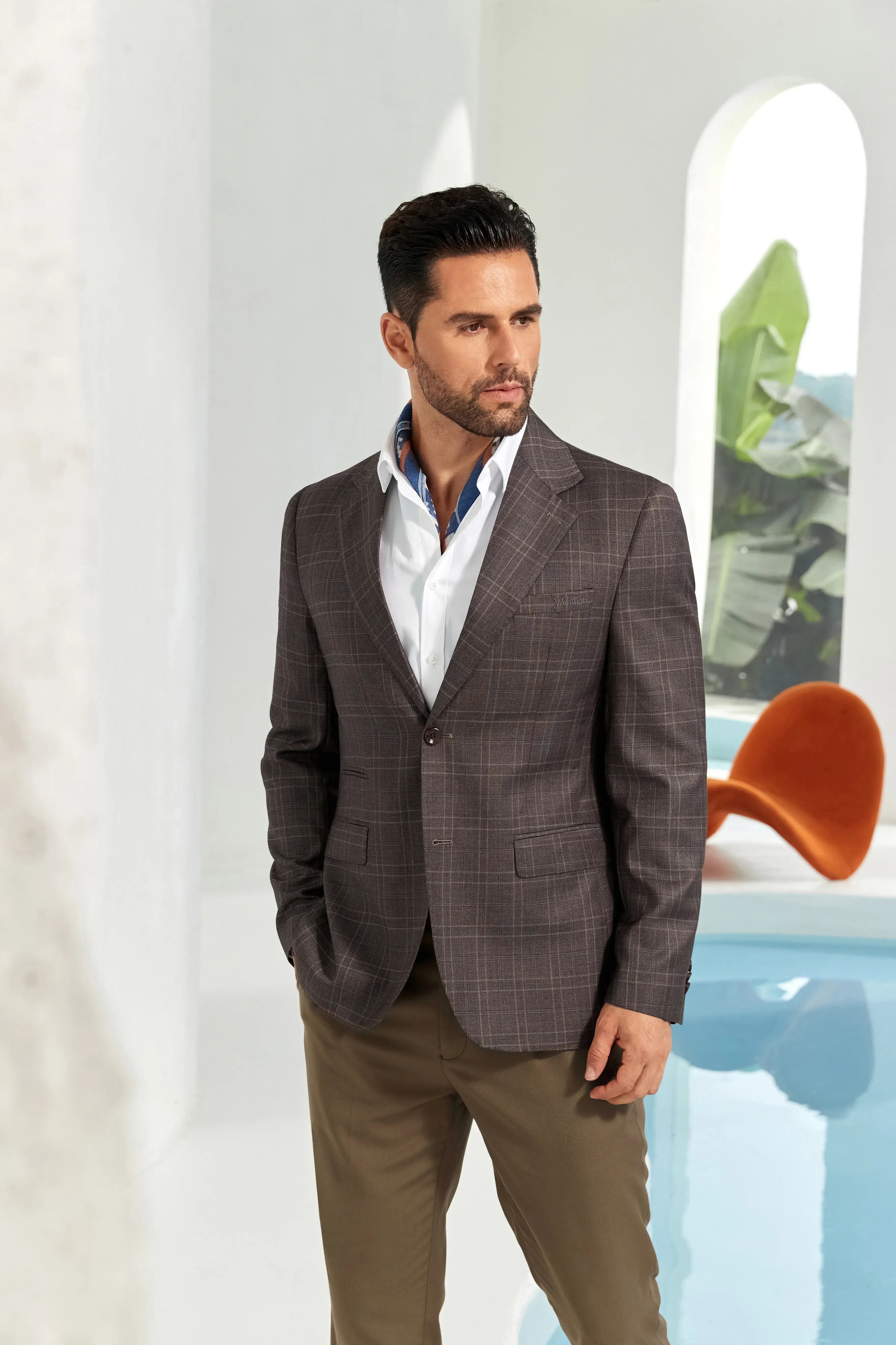 Model posing in a slim fit coffee check blazer for men, perfect for business or smart casual