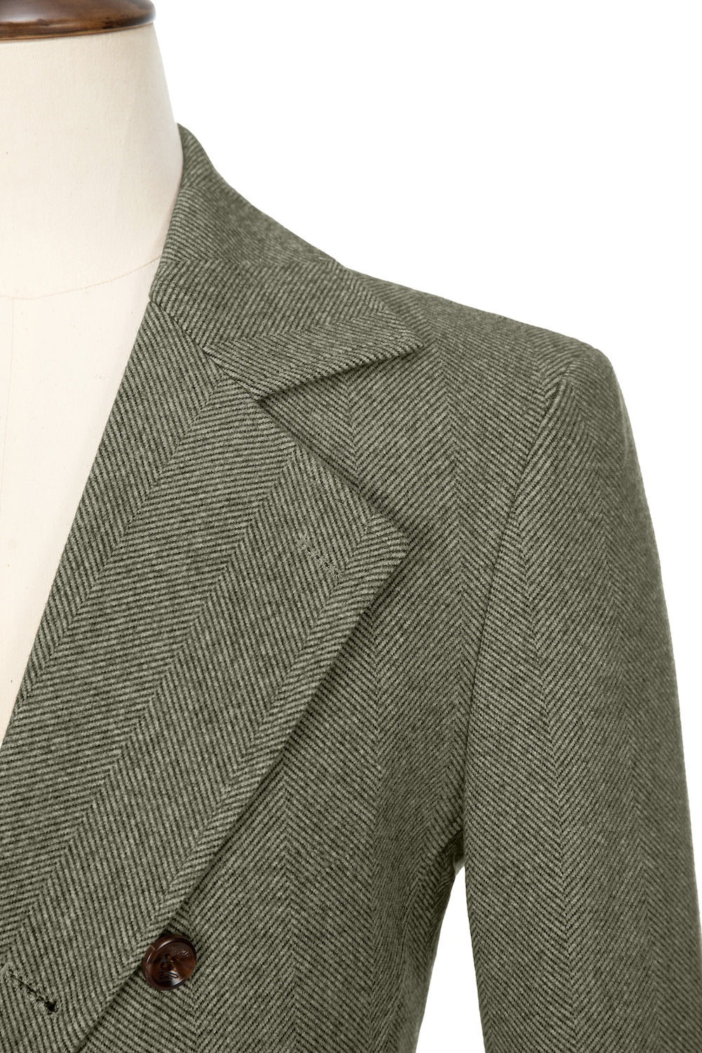 Dark green close-up of lapel detail on double-breasted wool coat