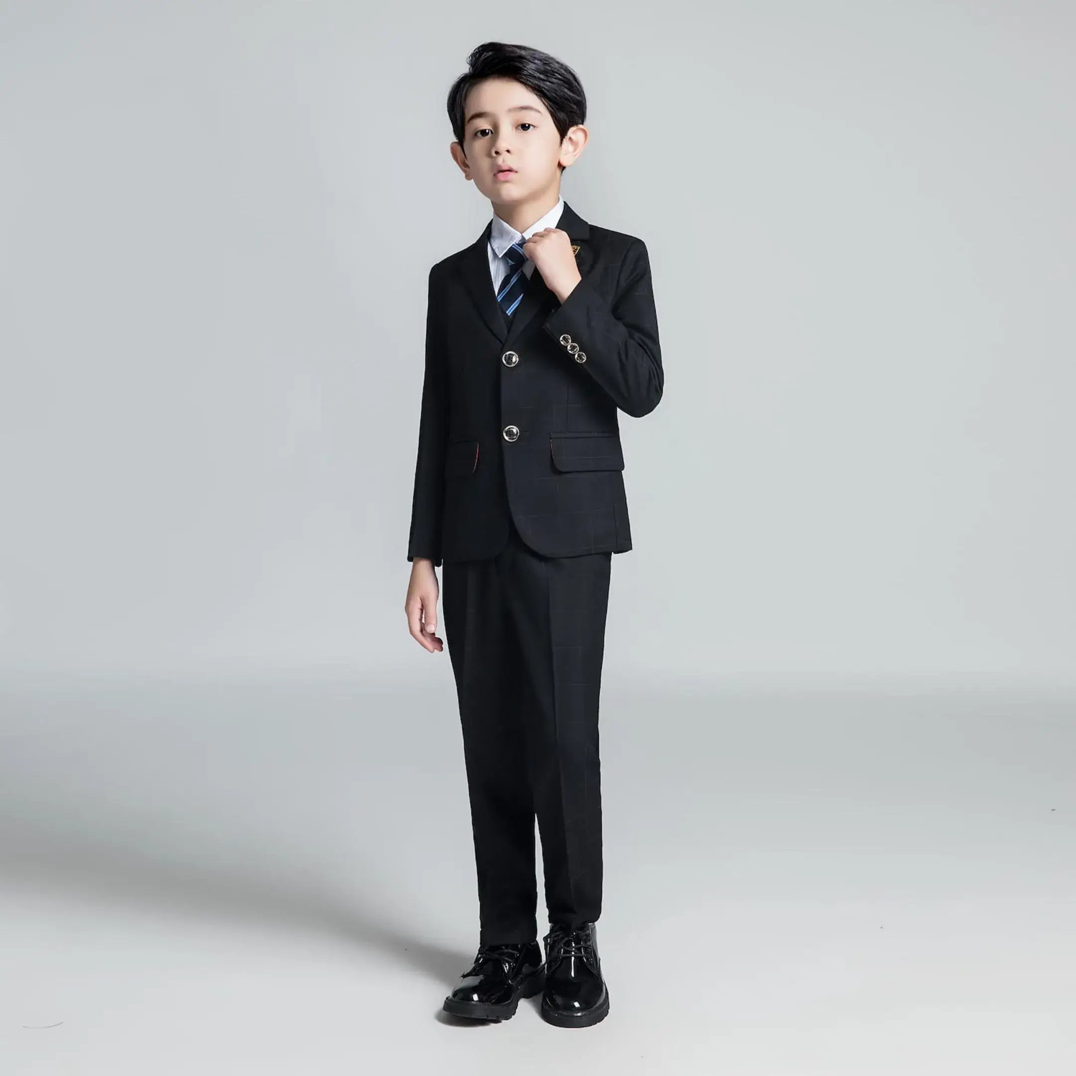 Boys' black plaid suit with striped tie and tailored jacket, ideal for weddings, photo shoots, and special occasions