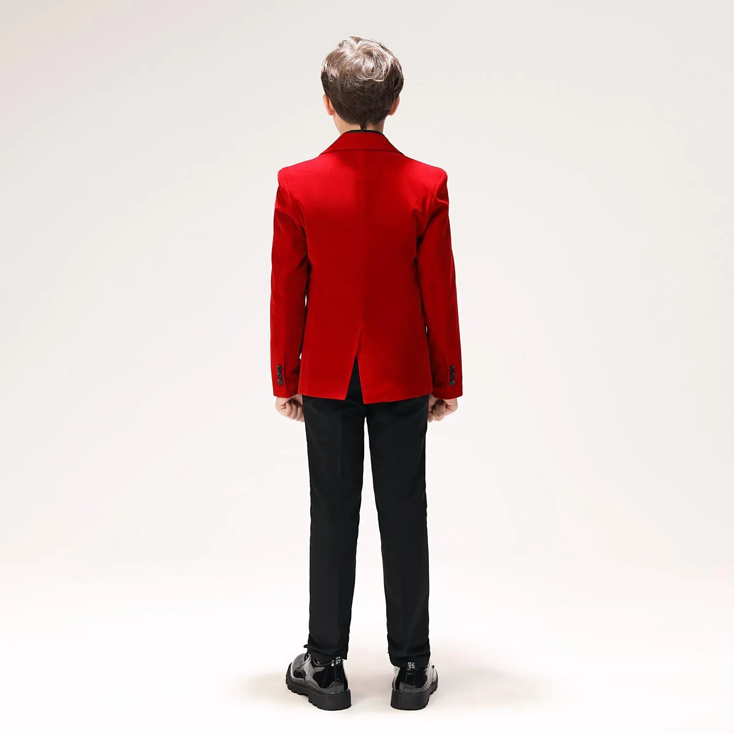 Back view of boys' red velvet blazer with center vent and sleek tailoring