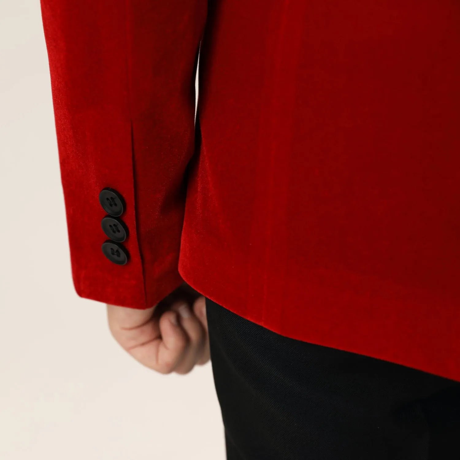 Sleeve detail of red velvet boys' jacket with three-button cuff – elegant finishing