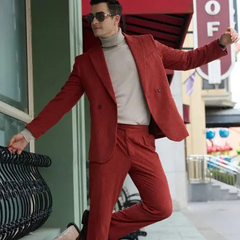 Stylish man in a vibrant red Wehilion exclusive double-breasted suit striking a dynamic pose on a city walkway, showcasing premium tailoring.