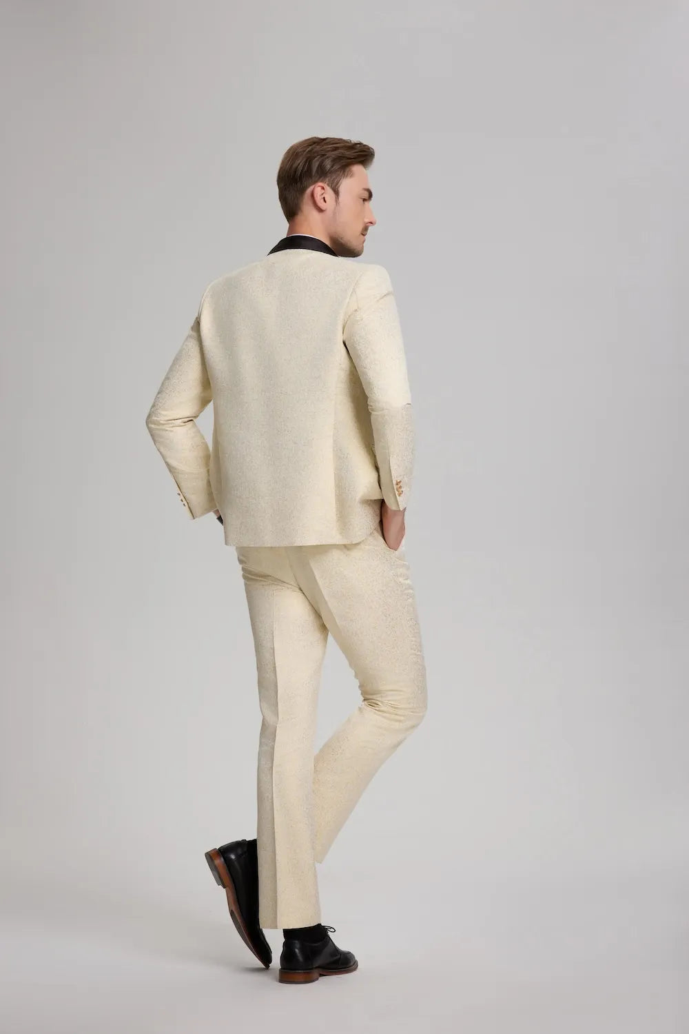 Rear view of white and gold tuxedo jacket showing the detailed shawl collar and back seam design.