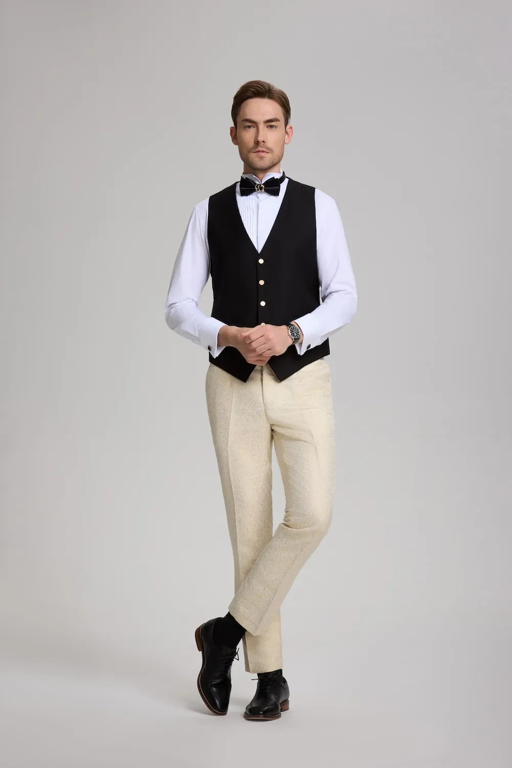 Men's gold pants and vest set styled with white dress shirt and black bow tie – perfect for prom.