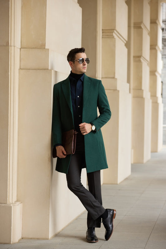Casual winter green trench coat paired with dark trousers and black shoes