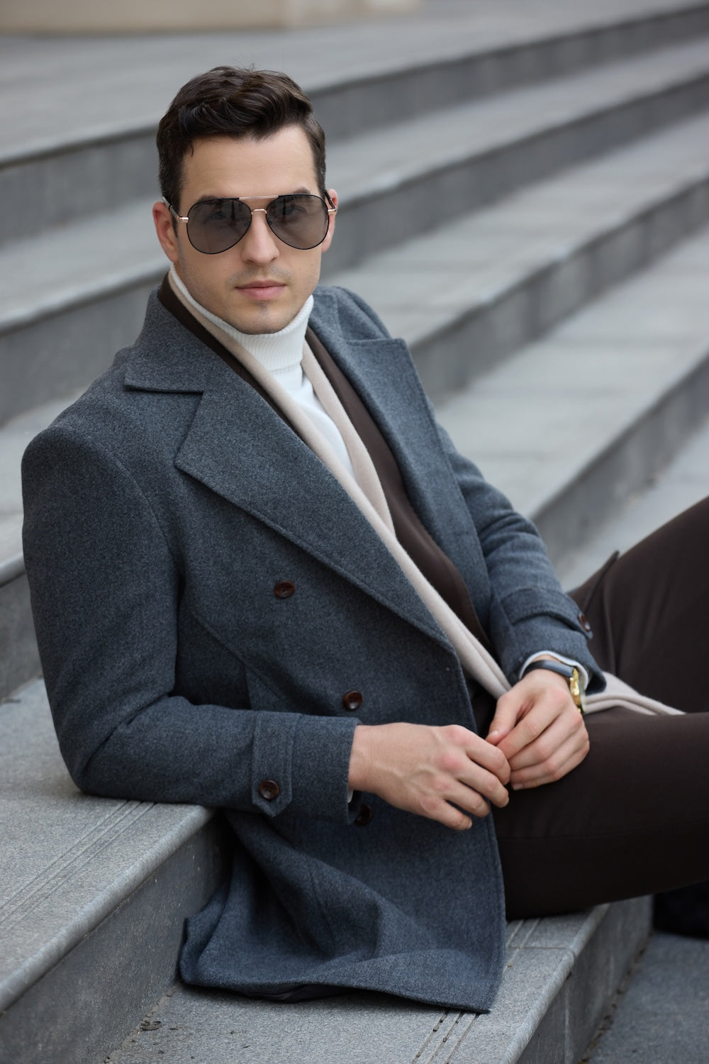 Man leaning on lamp post in grey long wool coat – city business winter style