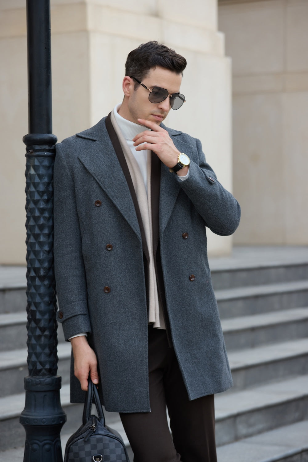 Side view of grey men’s winter business coat with peak lapel and button detail