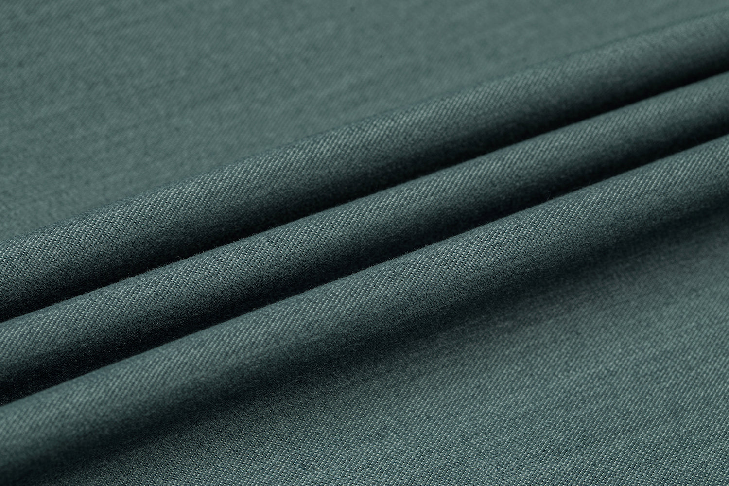 Men's sage green blazer fabric close-up - textured formal wedding jacket material with smooth weave