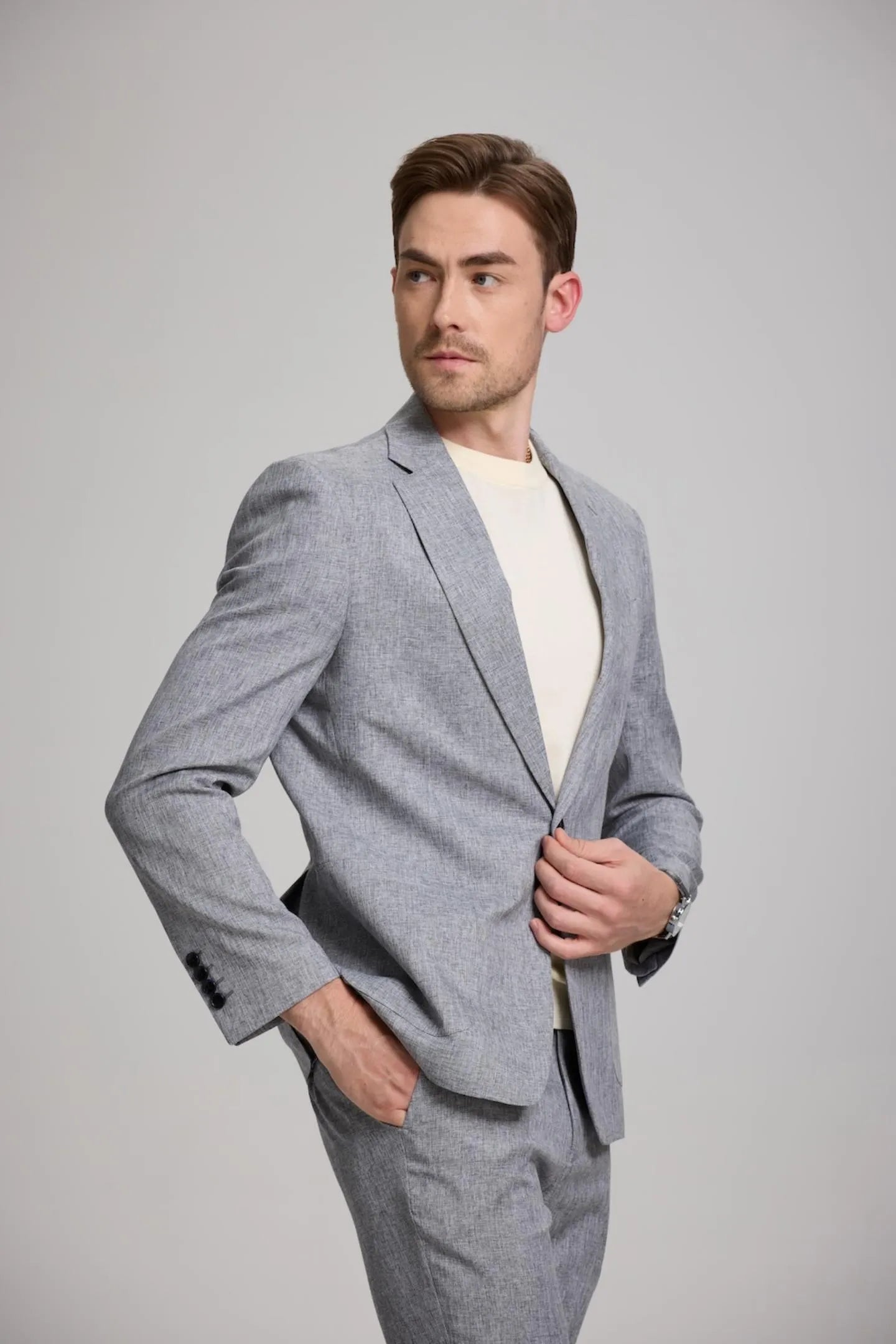 side view of men's grey slim fit 2-piece suit, showcasing a notch lapel blazer and trousers, offering a stylish, comfortable fit for casual outings.