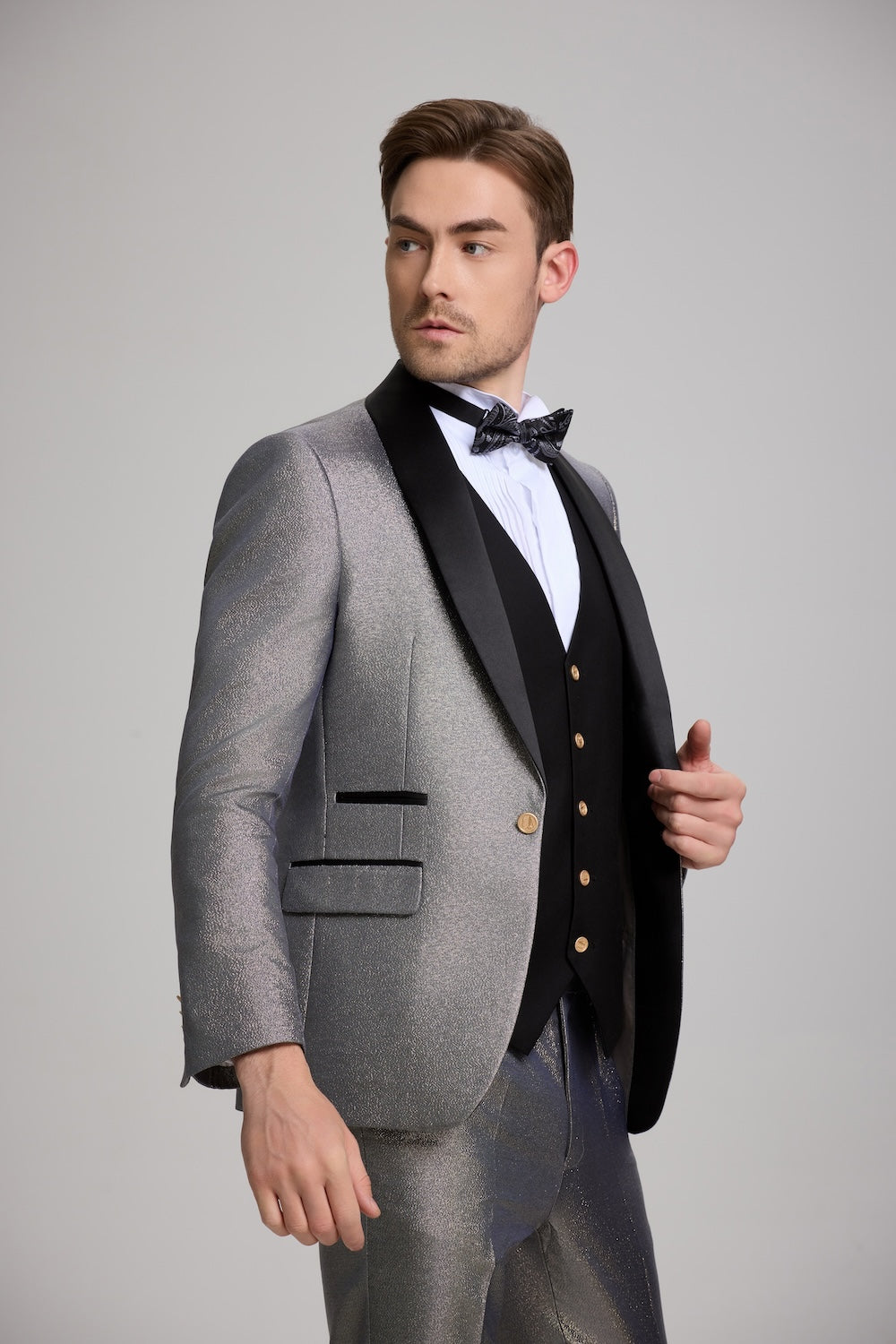 Close-up of grey men’s tuxedo suit with satin lapel and gold button details