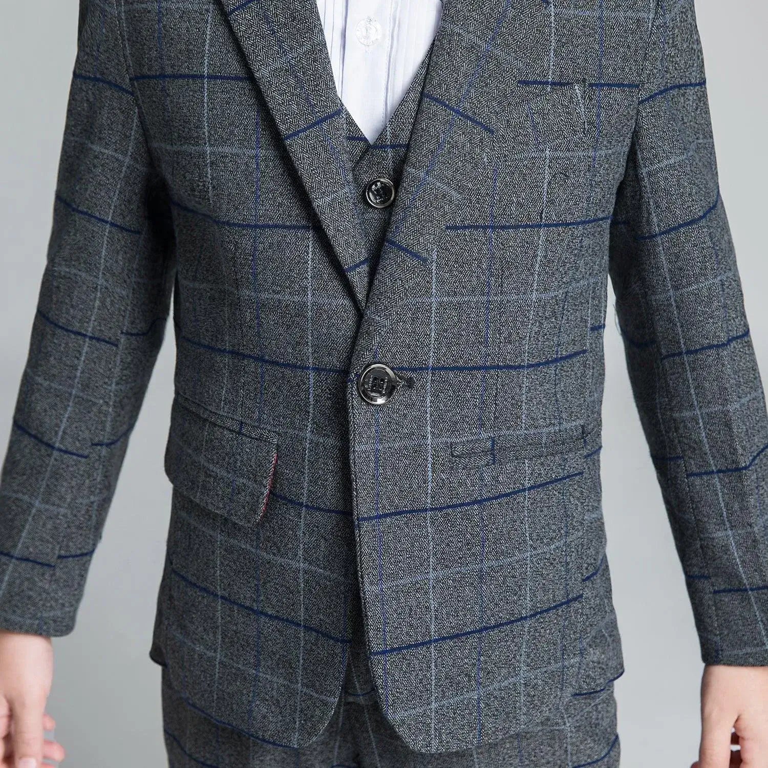 Boys' dark gray plaid suit: Close-up of checked blazer with black buttons