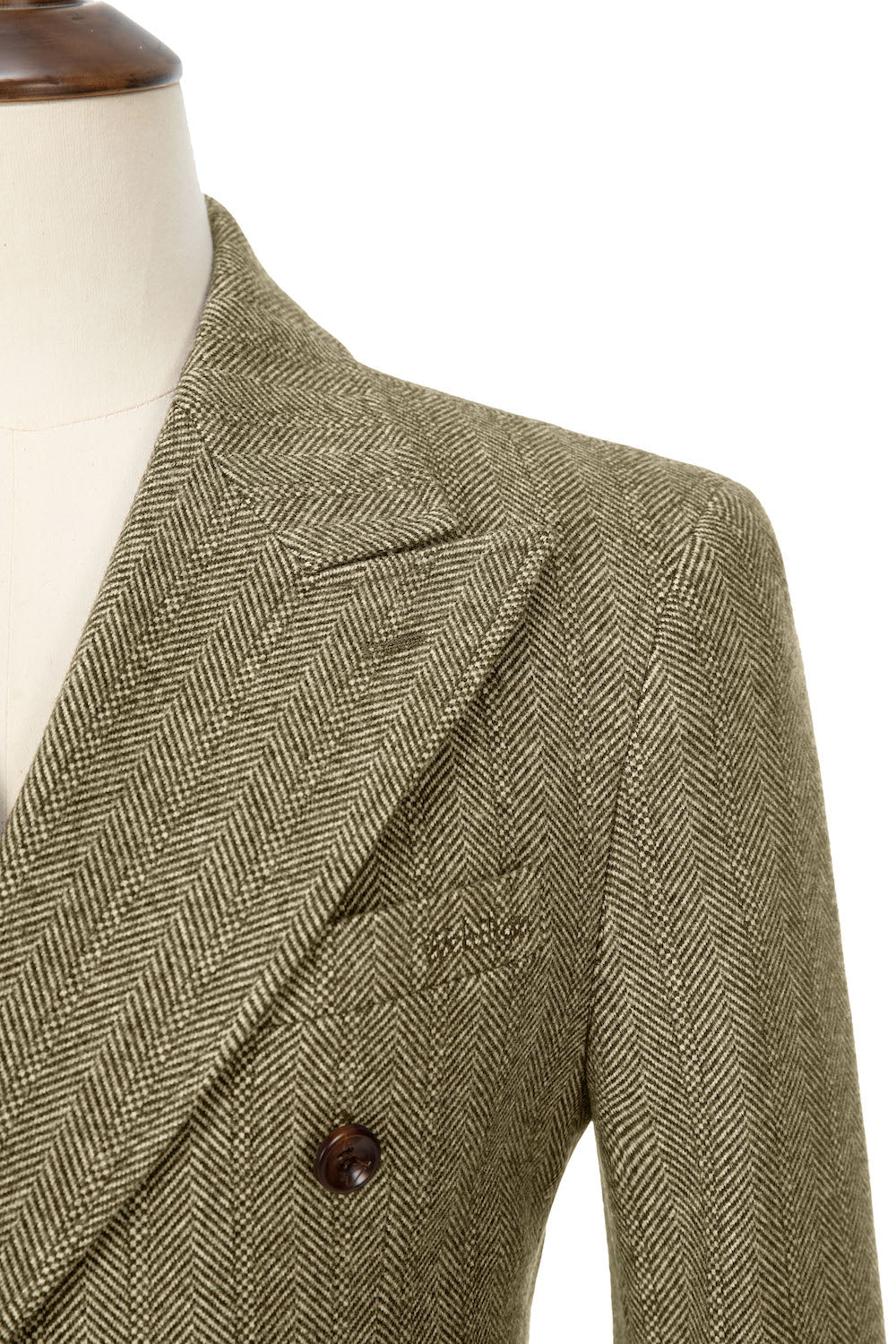 Men's khaki wool overcoat - close-up of herringbone pattern lapel & brown buttons on double breasted urban winter coat